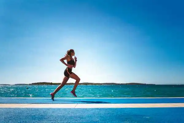 Woman running showing strong leg muscle City of London